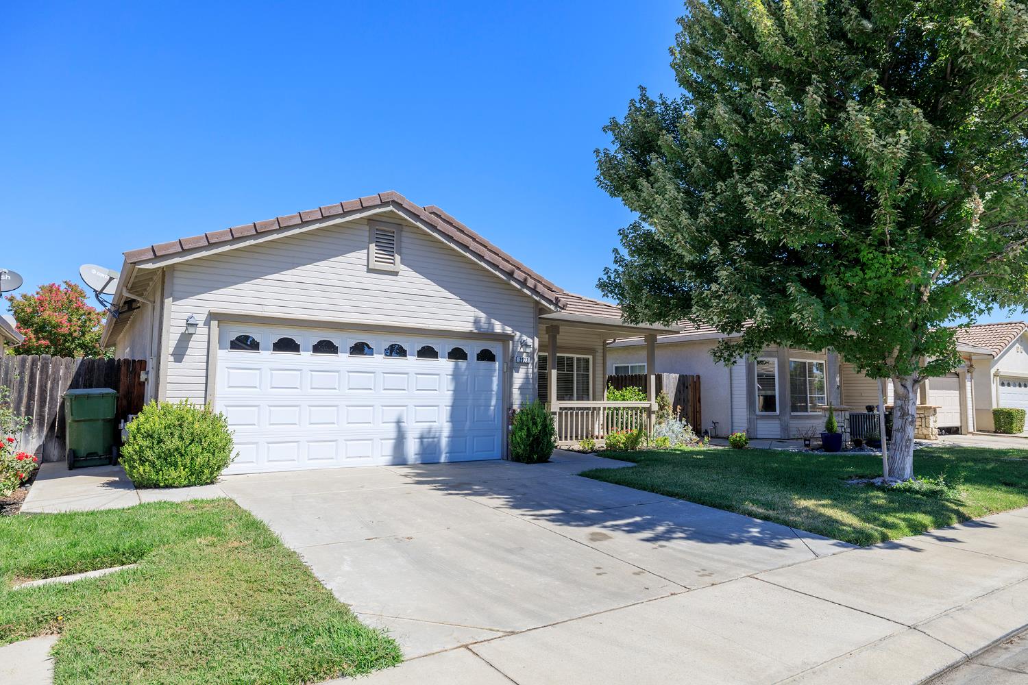 2123 Spring Blossom Lane Turlock, CA 95382 - Photo 2 of 44 a front view of a house with a yard and garage