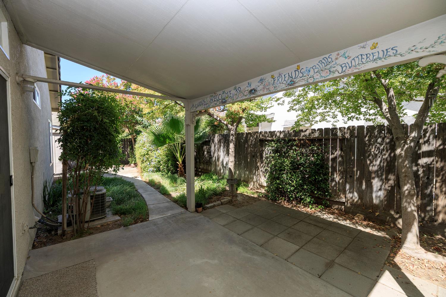 2123 Spring Blossom Lane Turlock, CA 95382 - Photo 25 of 44 a living room with large windows and a table and chairs
