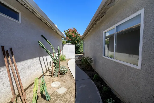 a vase of flowers sitting on a floor next to a window