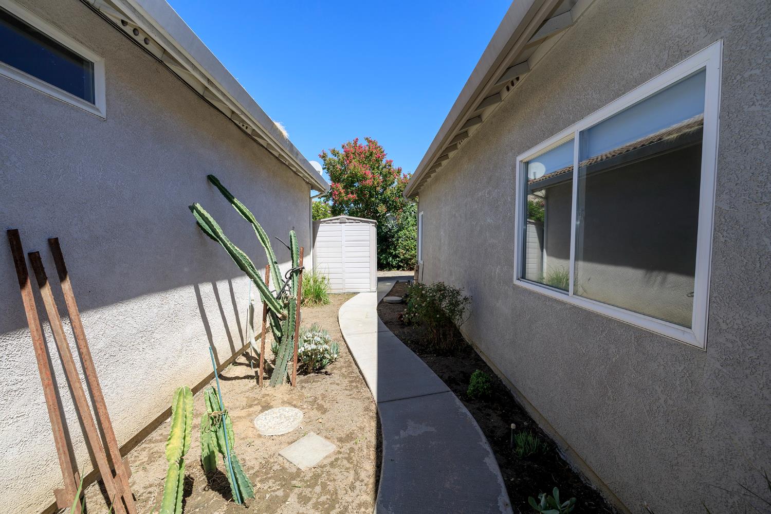 2123 Spring Blossom Lane Turlock, CA 95382 - Photo 33 of 44 a vase of flowers sitting on a floor next to a window