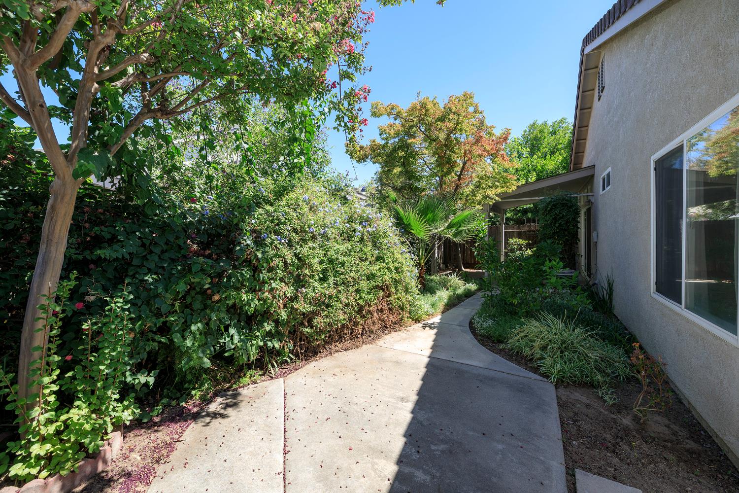 2123 Spring Blossom Lane Turlock, CA 95382 - Photo 36 of 44 a view of a pathway both side of the house