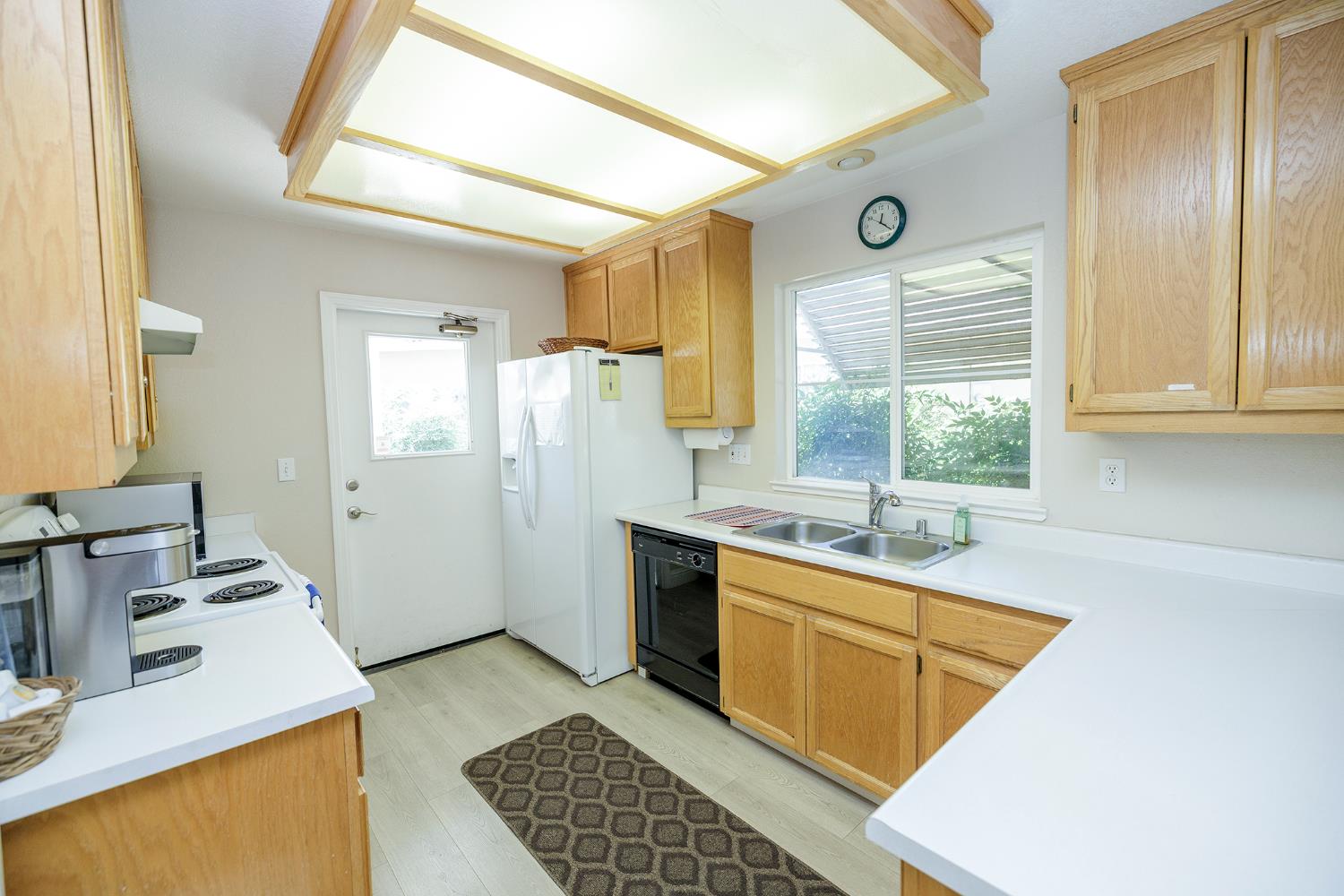 2123 Spring Blossom Lane Turlock, CA 95382 - Photo 42 of 44 a kitchen with sink refrigerator and window