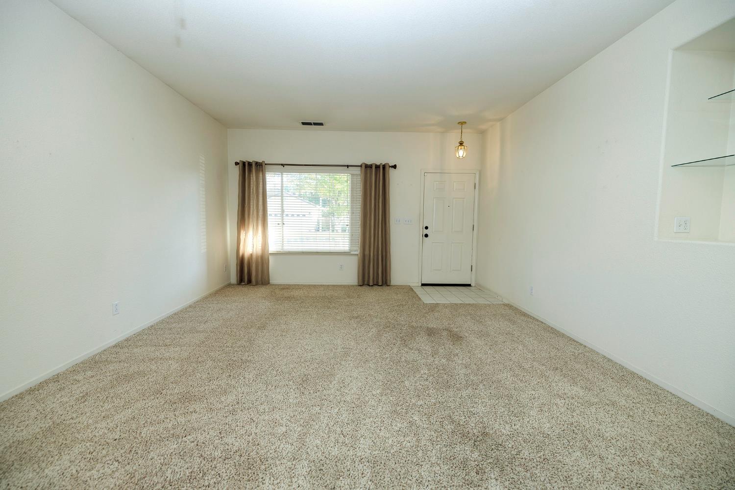 2123 Spring Blossom Lane Turlock, CA 95382 - Photo 7 of 44 an empty room with windows and closet