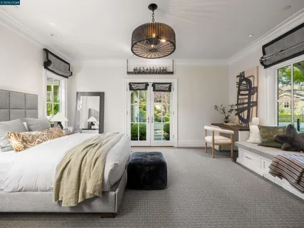 a dining room with furniture a rug and a floor to ceiling window