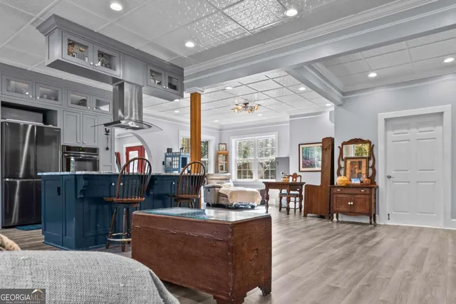 a kitchen with stainless steel appliances granite countertop a refrigerator and a sink