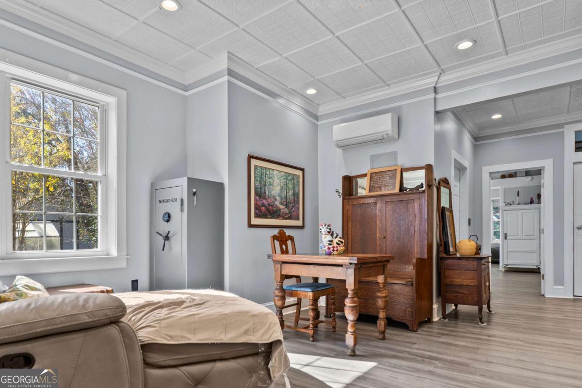 140 Jack Road Fitzgerald, GA 31750 - Photo 19 of 55 a bedroom with a bed and wooden floor