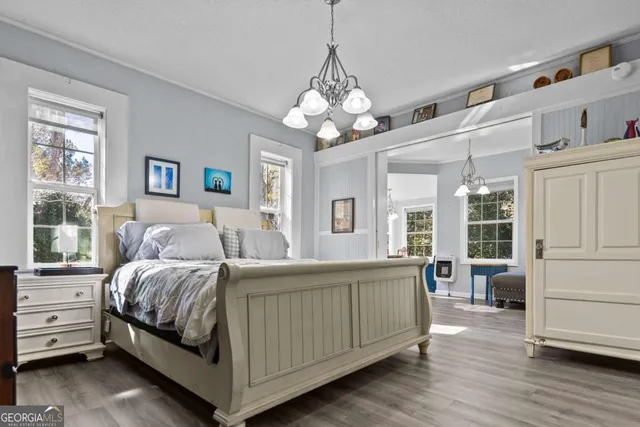 a living room with furniture a chandelier and a window