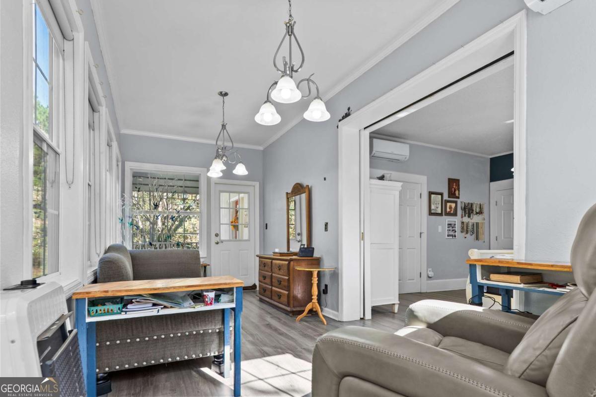 140 Jack Road Fitzgerald, GA 31750 - Photo 23 of 55 a living room with furniture a chandelier and a window