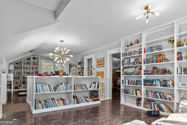 a very nice looking living room with a baby crib and a wooden floor