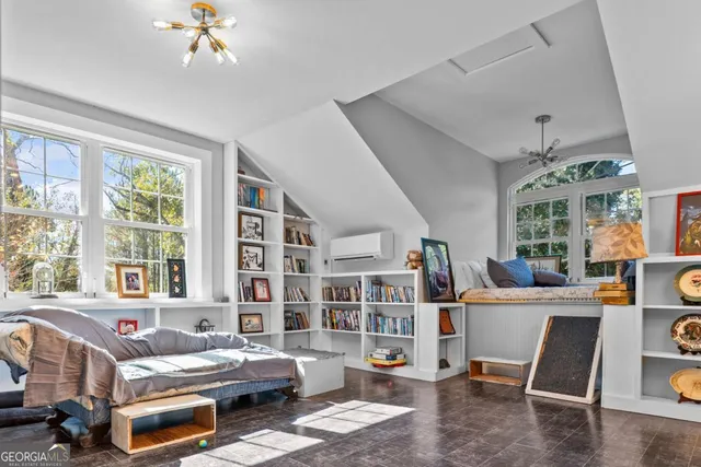 a view of a livingroom with furniture and a window