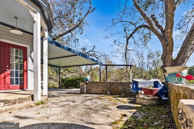 a view of a house with a yard and wooden fence