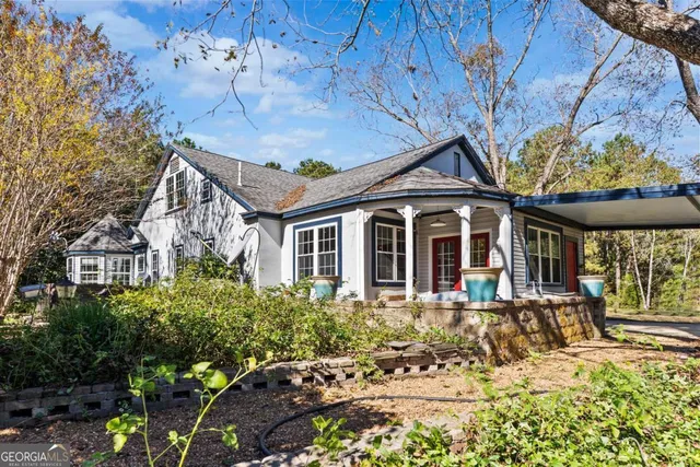 a view of a house with a yard and tree s
