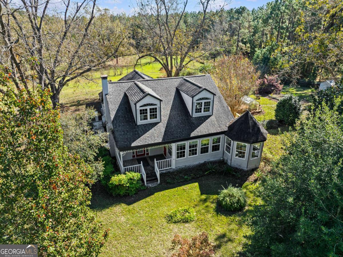 140 Jack Road Fitzgerald, GA 31750 - Photo 4 of 55 an aerial view of a house with a yard and large trees