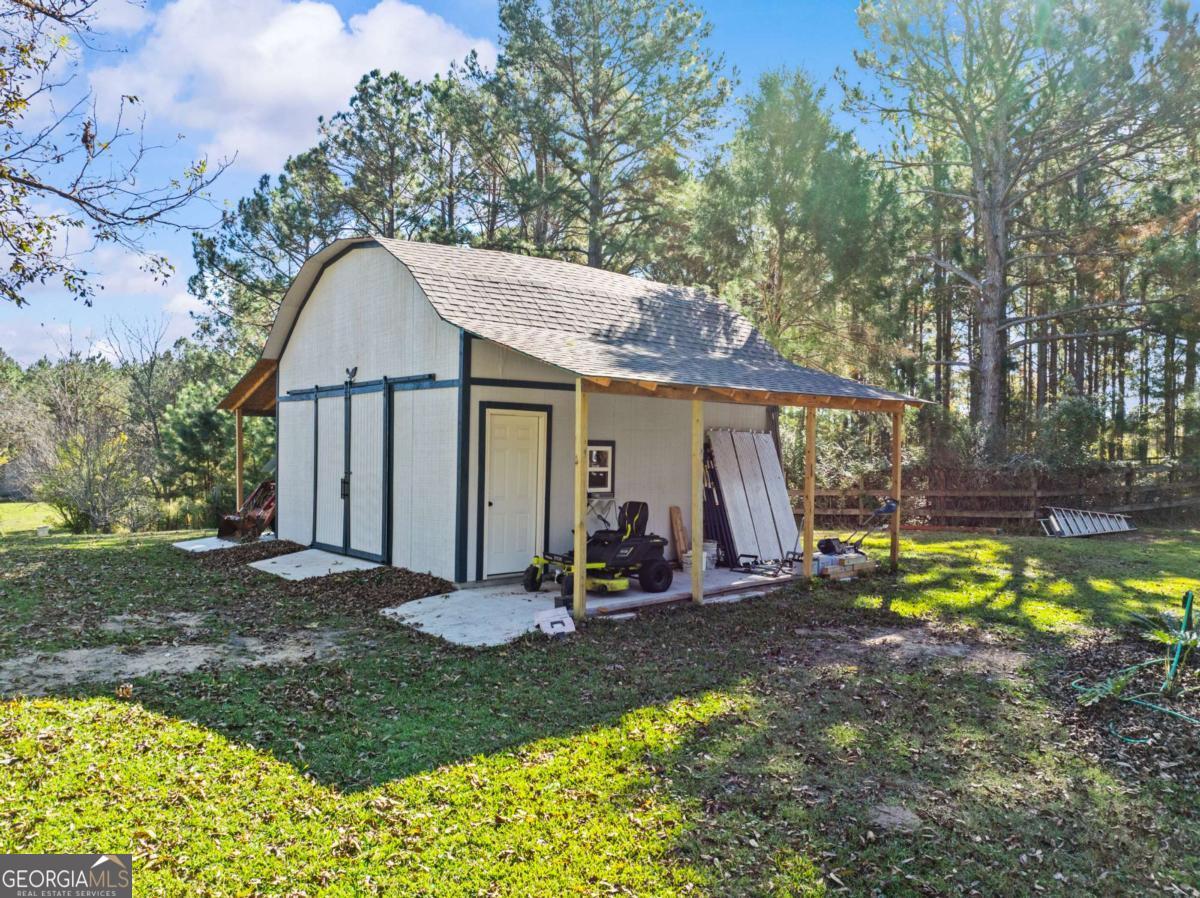 140 Jack Road Fitzgerald, GA 31750 - Photo 45 of 55 a view of a house with backyard and chairs