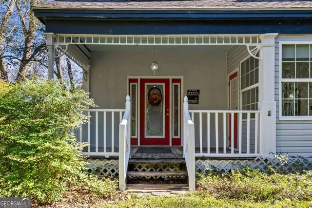 a front view of a house with plants