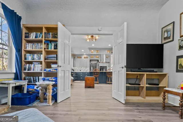 a living room with furniture and a wooden floor