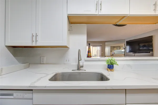 a kitchen with a sink and a microwave