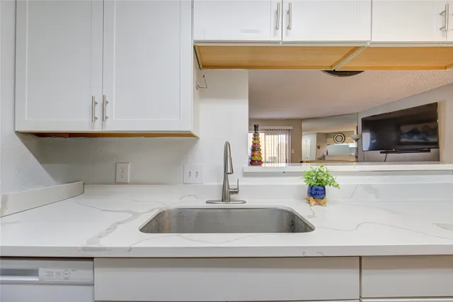 a kitchen with a sink and a microwave