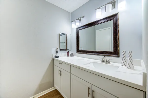 a bathroom with a double vanity sink and a mirror