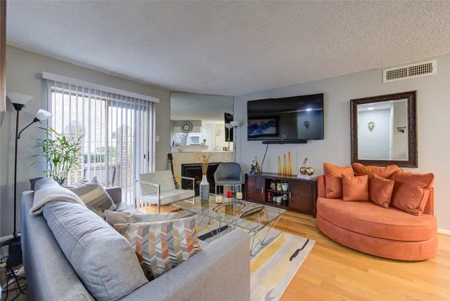 a living room with fireplace furniture and a flat screen tv