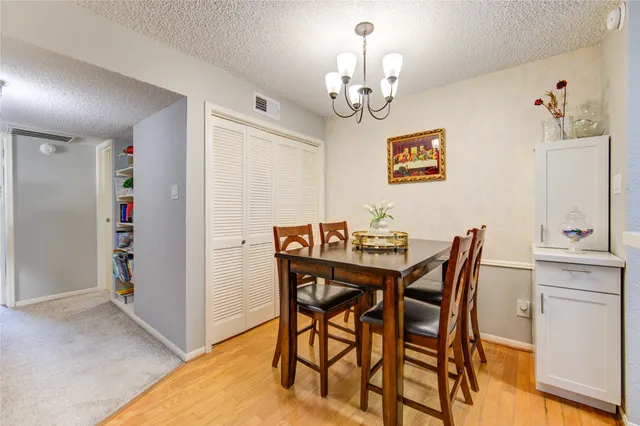 a view of a dining room with furniture and chandelier