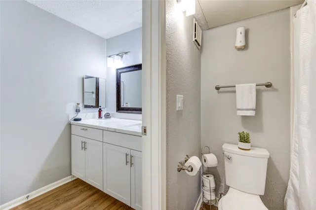 a bathroom with a sink mirror vanity and toilet