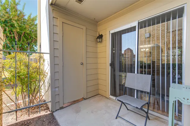 a view of balcony with two chairs and a potted plant