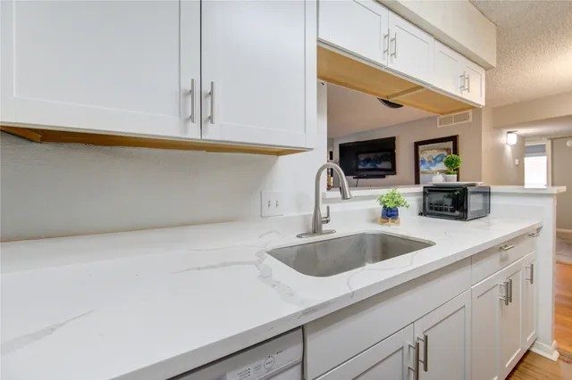 a kitchen with a sink and cabinets