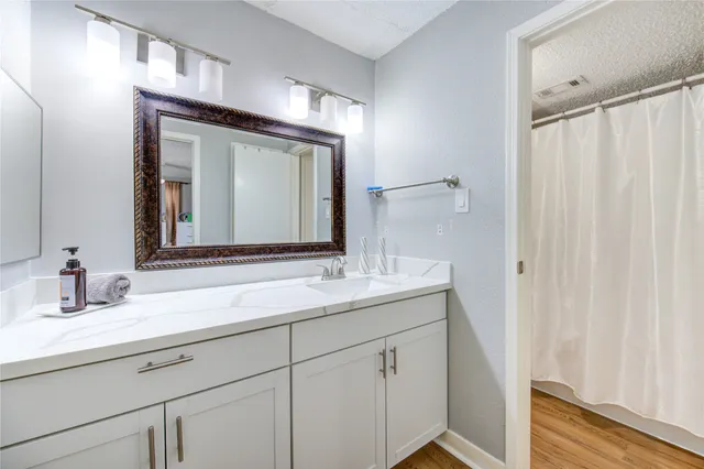 a bathroom with a double vanity sink and a mirror