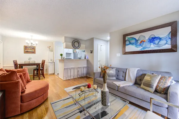 a living room with furniture and painting on the wall