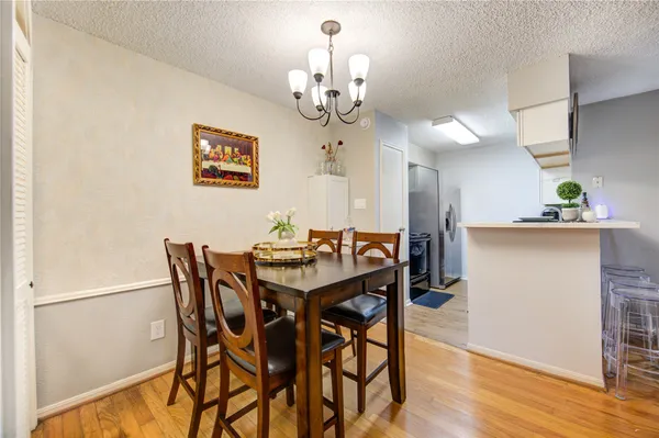 a view of a dining room with furniture and chandelier