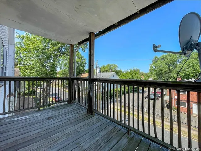 a view of balcony with wooden floor
