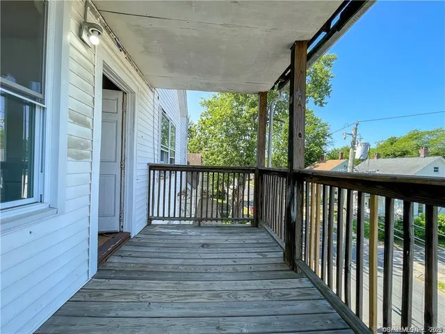 a view of a balcony with wooden floor