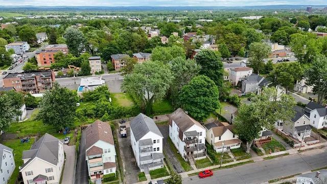 an aerial view of residential house with outdoor space and trees all around