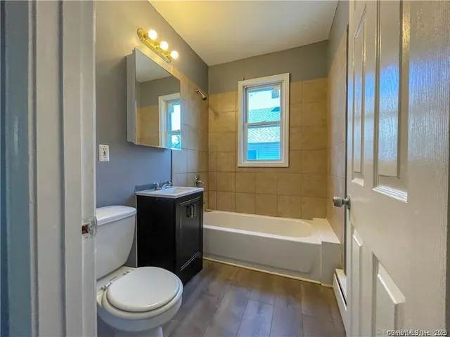 a bathroom with a toilet a sink and bathtub