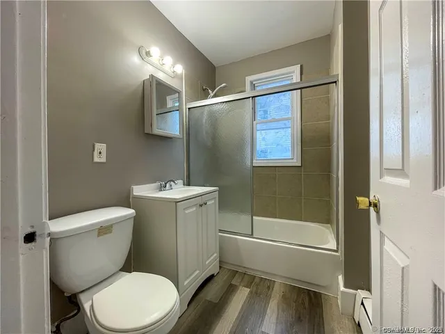 a white toilet sitting next to a bath tub shower