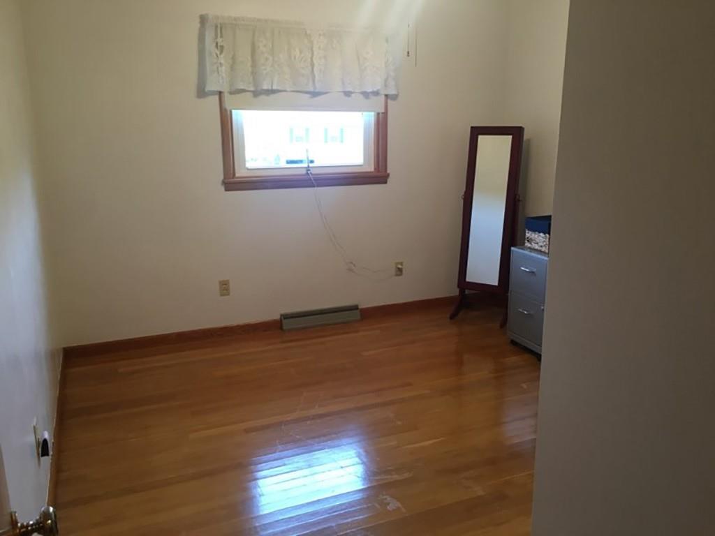 818 Barclay Road Indiana, PA 15701 - Photo 9 of 15 an empty room with wooden floor and windows