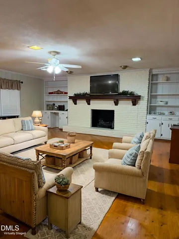 a living room with furniture and a view of kitchen