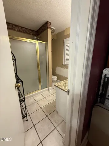 a bathroom with a shower and a sink