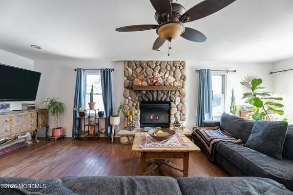 a living room with furniture a fireplace and a flat screen tv