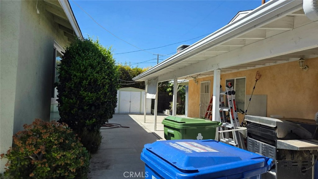 19843 Enadia Way, Unit RISE Winnetka, CA 91306 - Photo 11 of 20 a view of a patio with table and chairs potted plants and floor to ceiling window