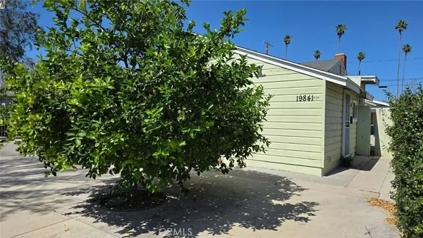 a view of a house with a tree