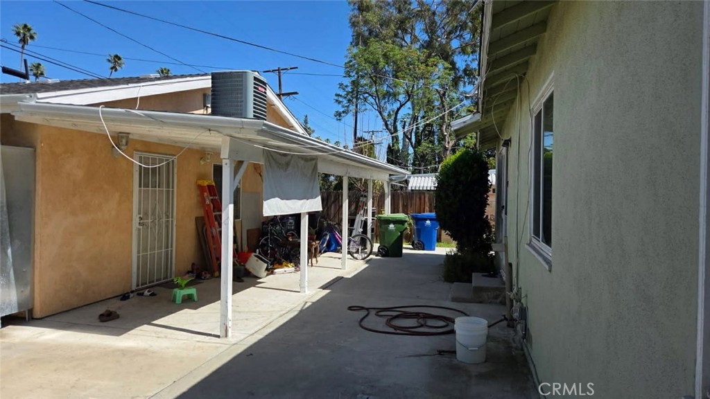 19843 Enadia Way, Unit RISE Winnetka, CA 91306 - Photo 19 of 20 a view of a patio with table and chairs and potted plants