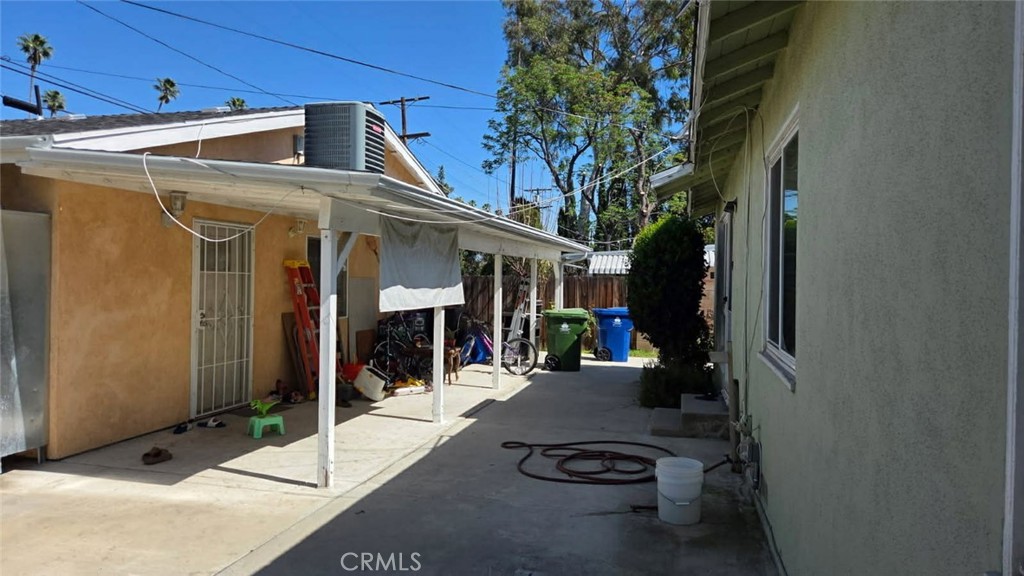 19843 Enadia Way, Unit RISE Winnetka, CA 91306 - Photo 20 of 20 a view of a patio with table and chairs and potted plants