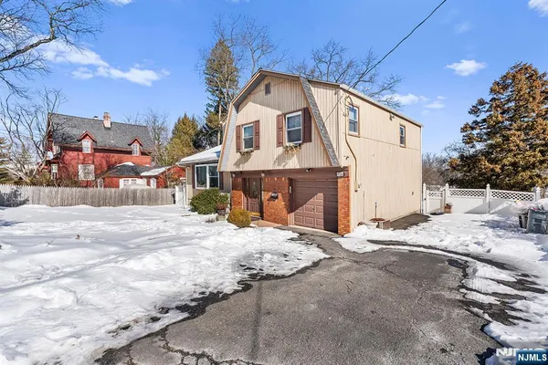 a view of a house with a snow in the background