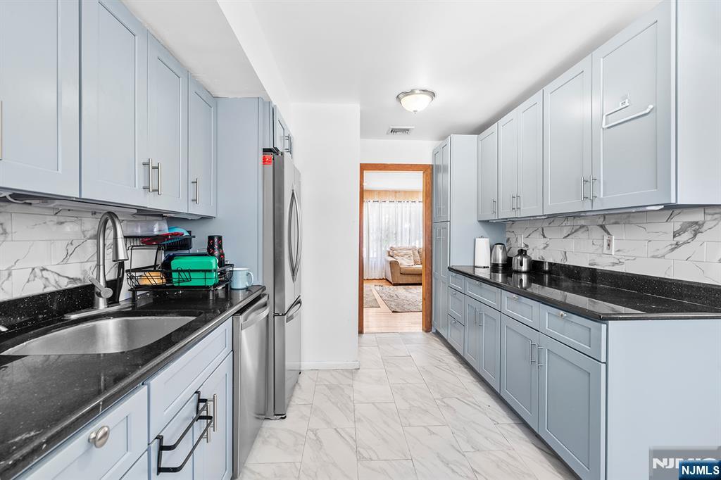 406 Kinderkamack Road River Edge, NJ 07661 - Photo 5 of 18 a kitchen with stainless steel appliances granite countertop a sink stove and refrigerator