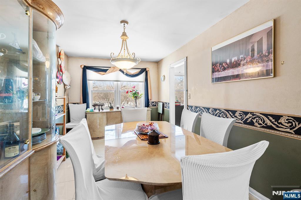 406 Kinderkamack Road River Edge, NJ 07661 - Photo 6 of 18 a view of a dining room with furniture a chandelier and wooden floor
