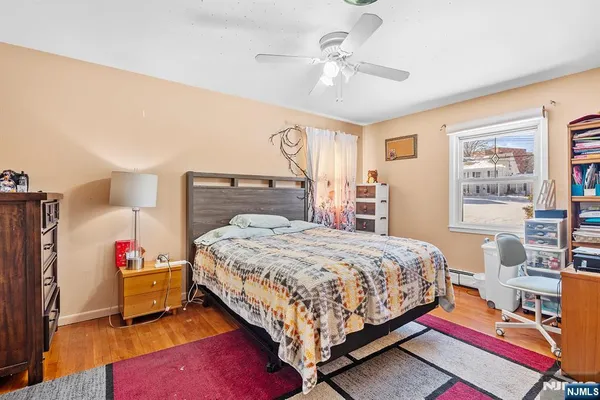 a bedroom with a bed a dresser and book shelf