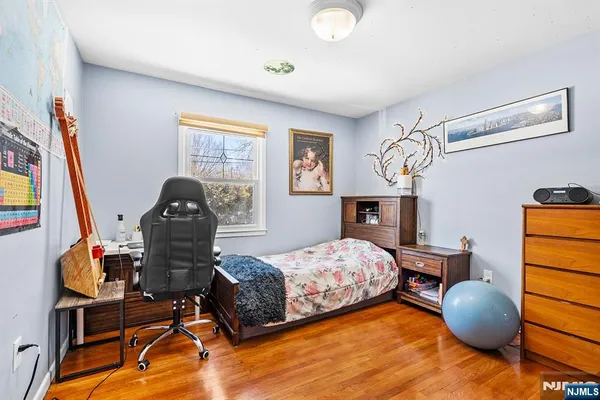 a bedroom with furniture and a wooden floor