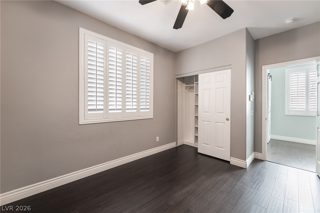 261 Timber Hollow Street Henderson, NV 89012 - Photo 24 of 51 Natural light streams into this bedroom, featuring sleek wood flooring and convenient closet storage.